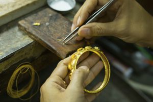 Goldsmith working with a unfinished work.