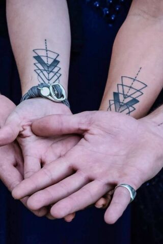Four arms display matching geometric linework tattoos near their elbows