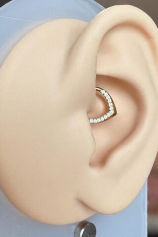 Close-up of a mannequin ear wearing a small heart-shaped stud